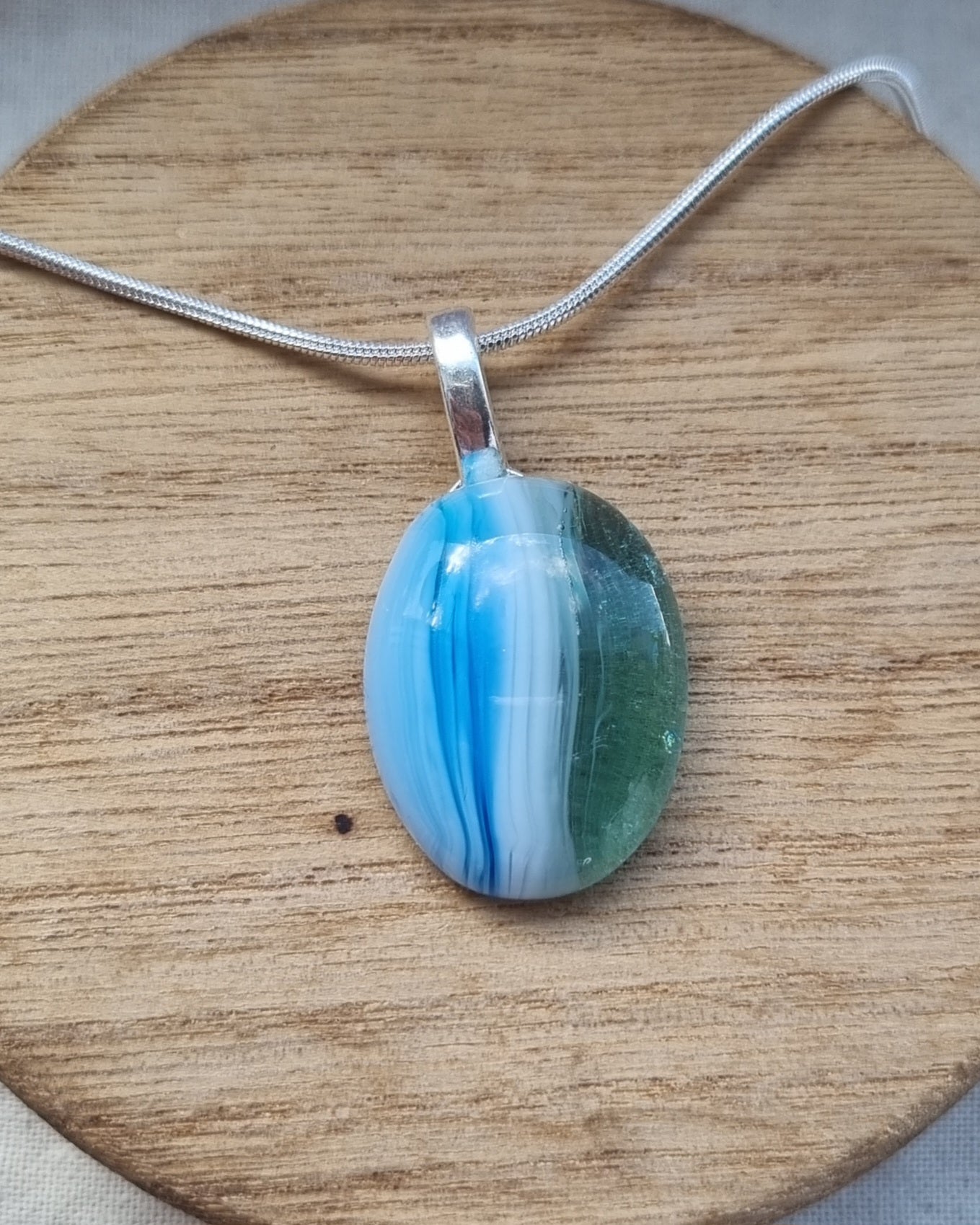 Ocean inspired, blue white and green, handmade glass pebble pendant