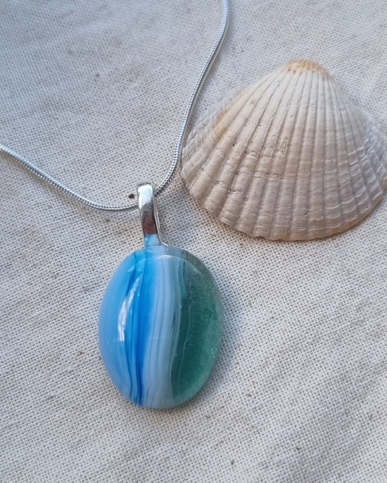 Ocean inspired, blue white and green, handmade glass pebble pendant