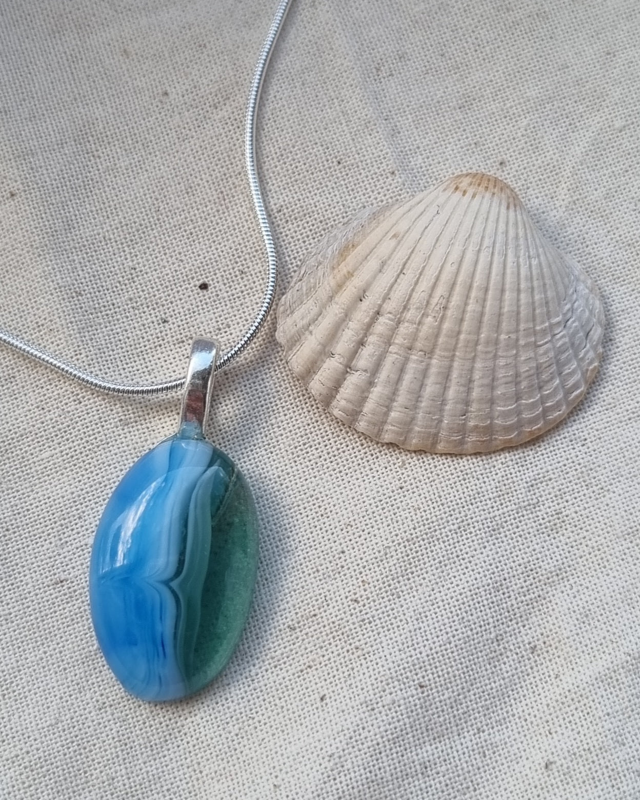 Ocean inspired, and green, handmade glass pebble pendant