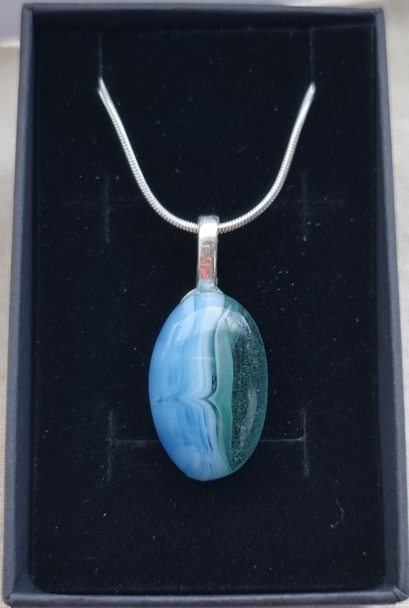Ocean inspired, and green, handmade glass pebble pendant