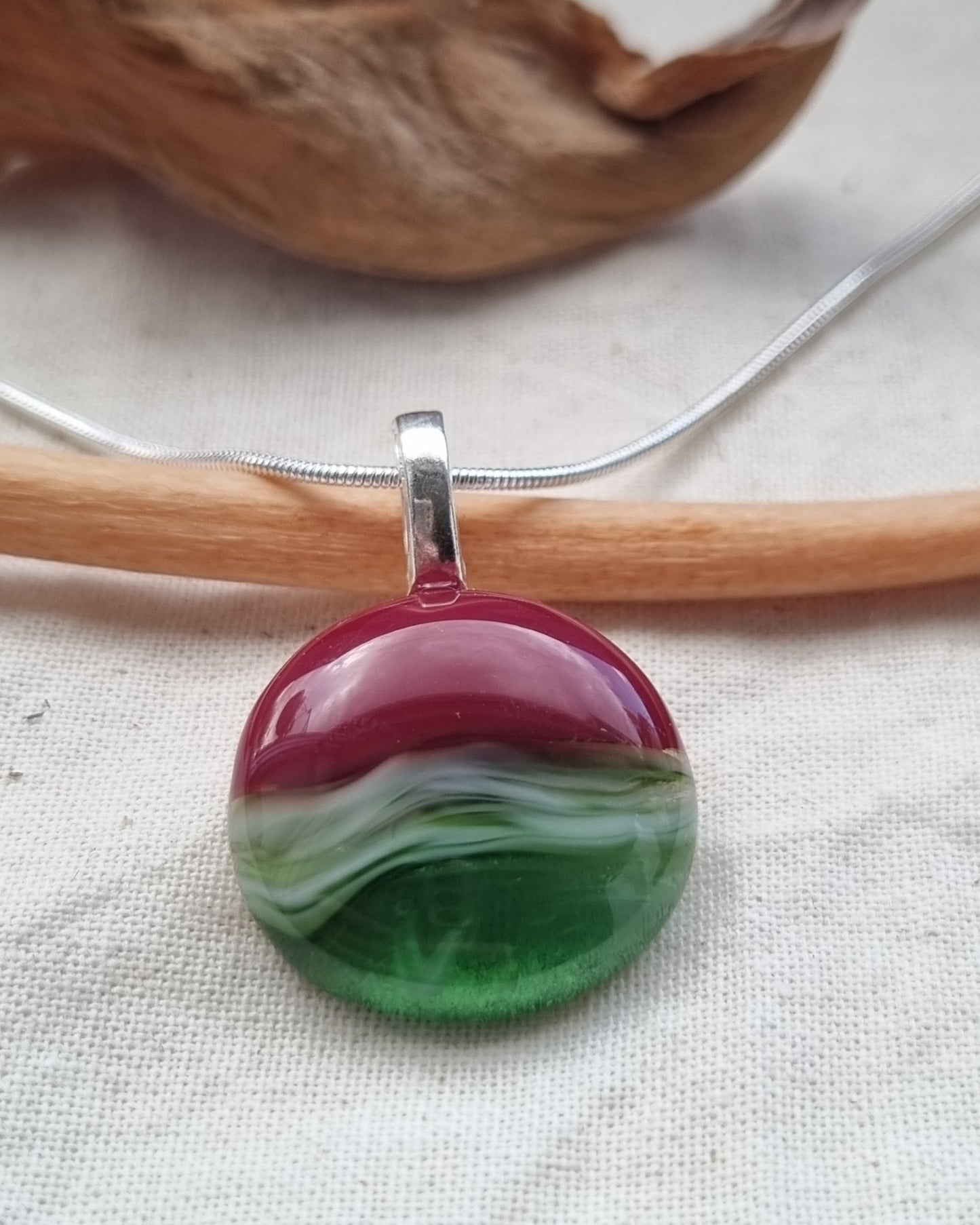 Shades of greens and red, handmade glass pebble pendant