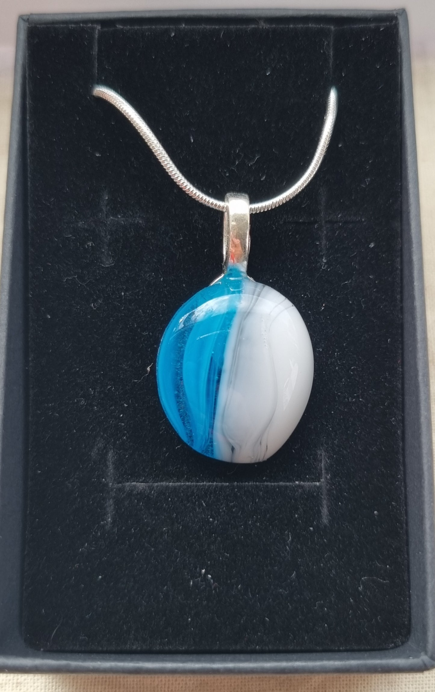 Handmade blue, grey and white glass pebble pendant