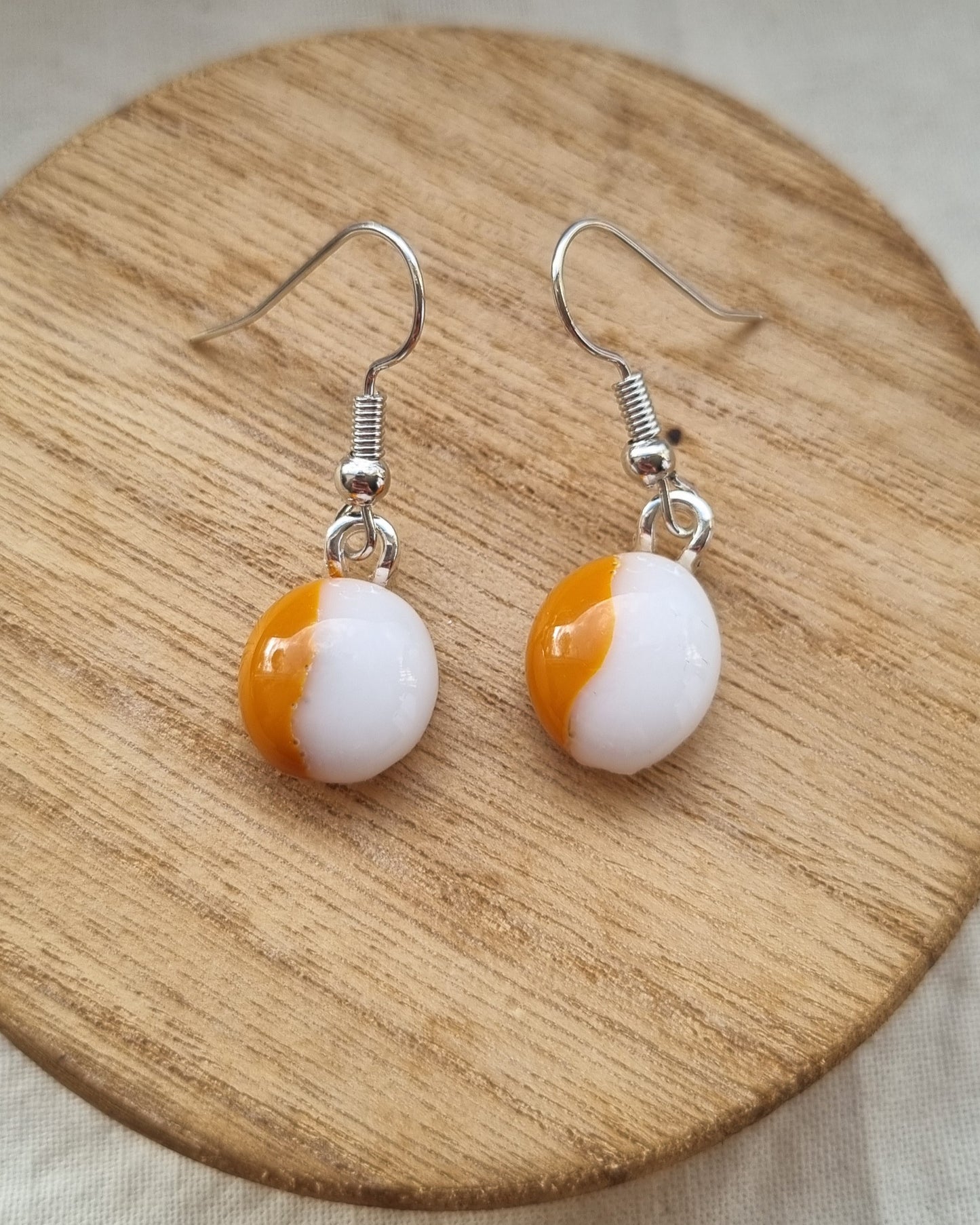 Orange and white, handmade glass pebble earrings