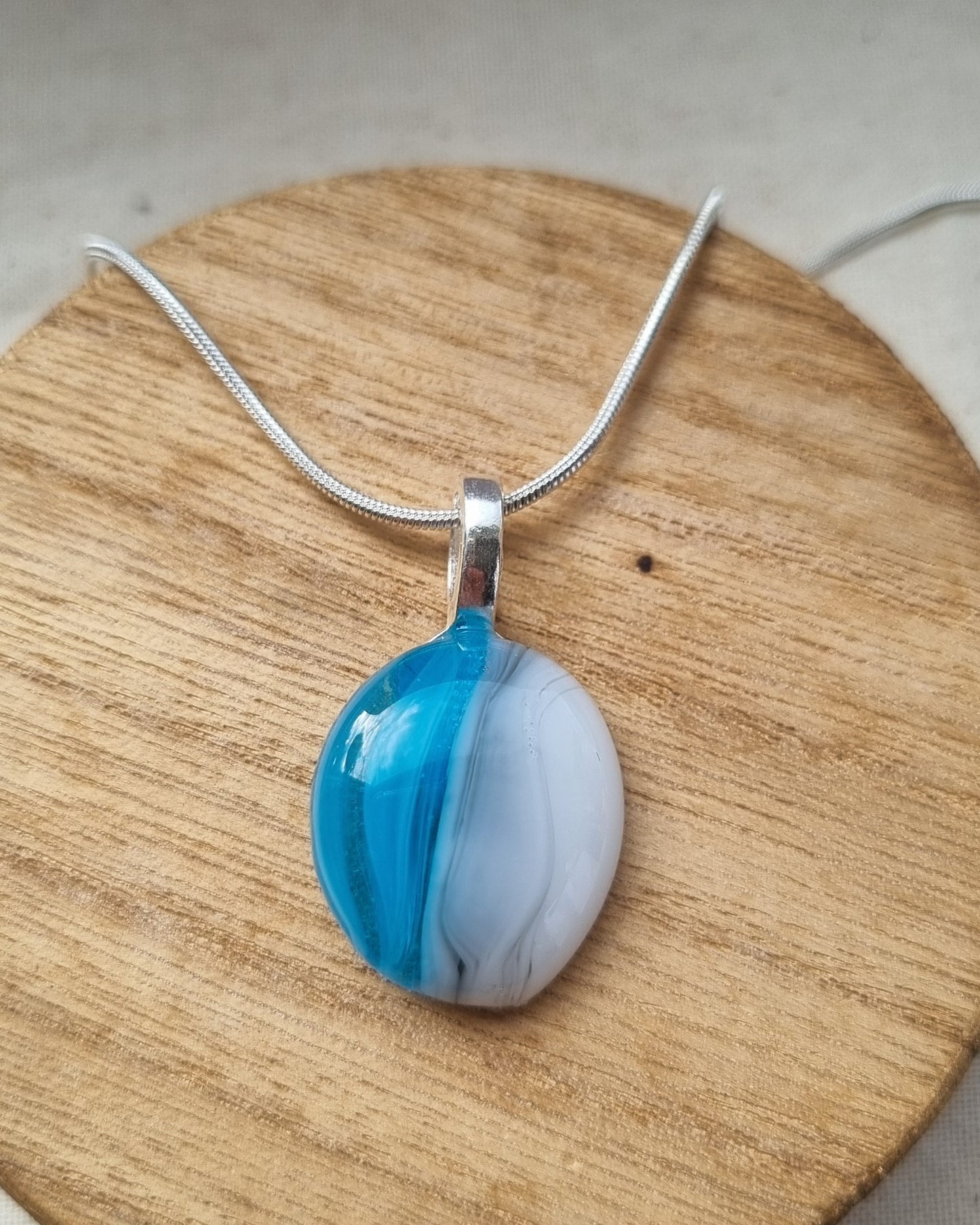 Handmade blue, grey and white glass pebble pendant