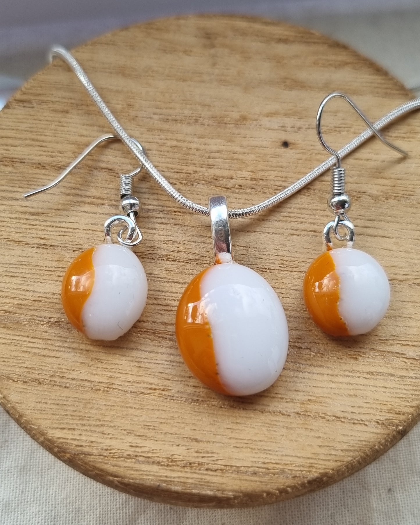 Orange and white, handmade glass pebble earrings