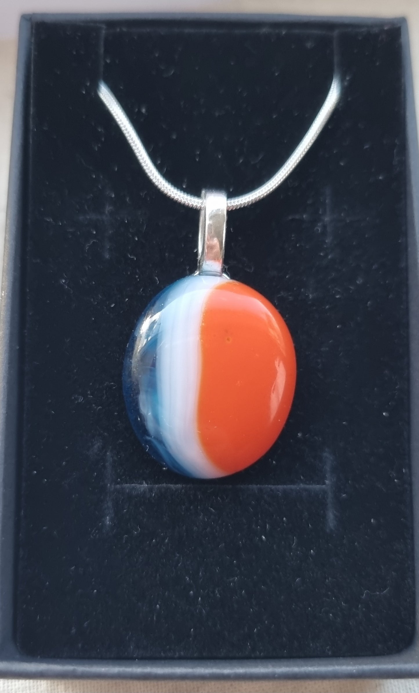 Blue, orange and white, handmade glass pebble pendant.
