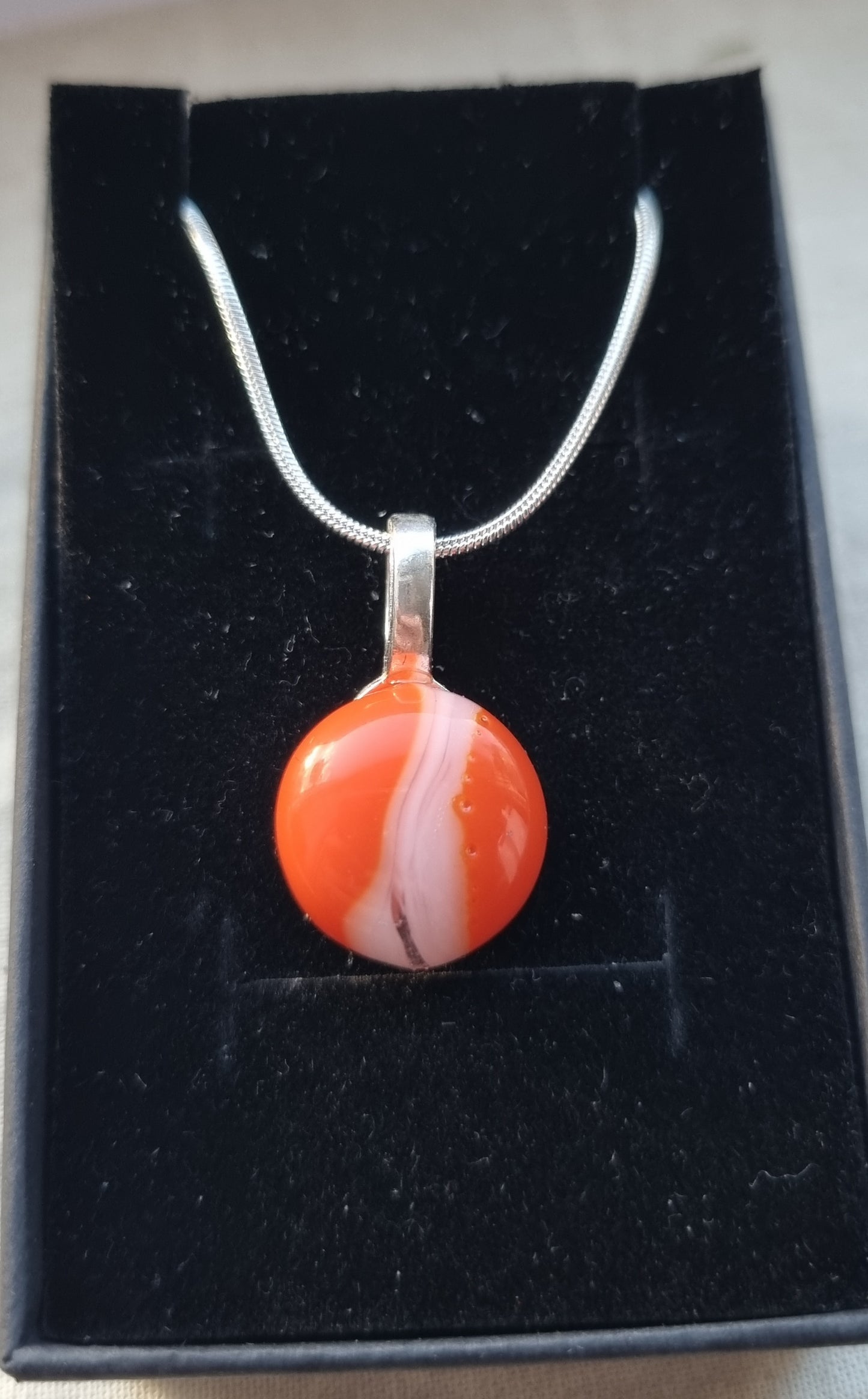 Orange and white, handmade glass pebble pendant